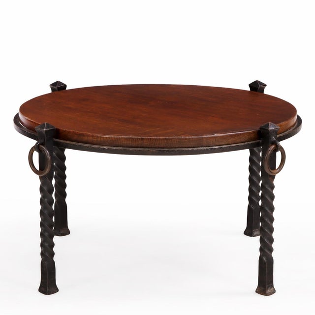 Striking French Brutalist style coffee table dating to circa 1960, featuring a round oak top inset within a substantial...