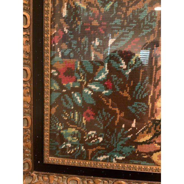 Exquisitely done needlepoint with a gorgeous wood frame. The artist shows a quaint depiction of a child carrying a young...