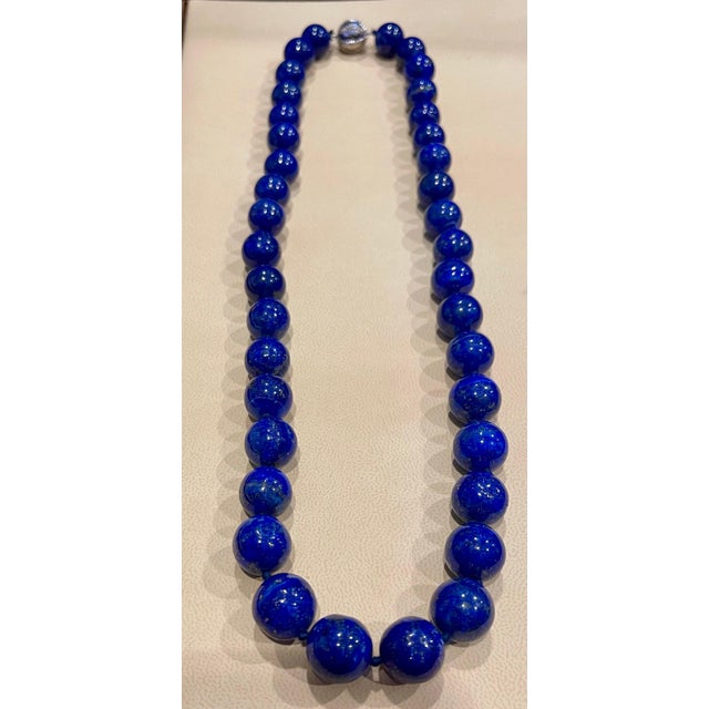 Vintage Lapis Lazuli Single Strand Necklace with 1.1 Carat Diamond Ball Clasp in 14 Karat White Gold This marvelous...