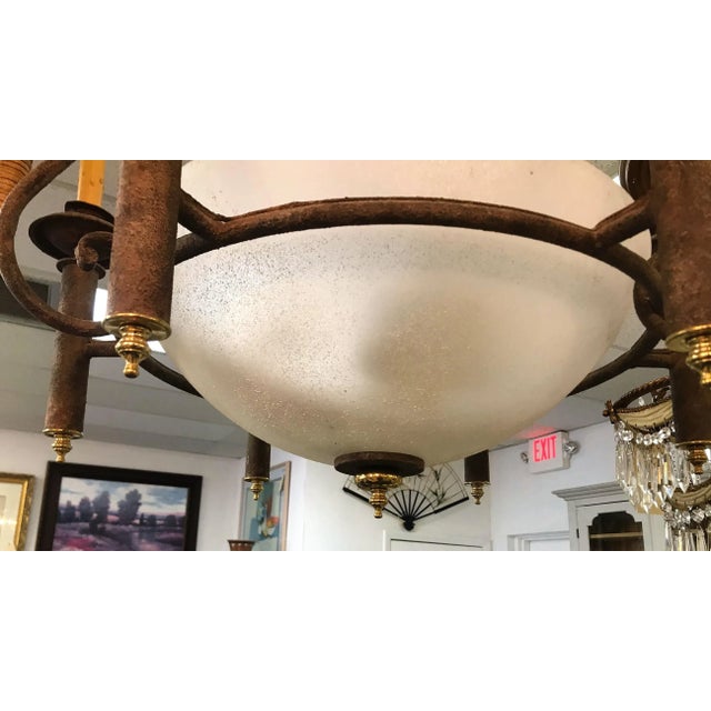 Very cool vintage Neoclassical chandelier. It has an oversized white glass bowl shape with three lights inside. There are...