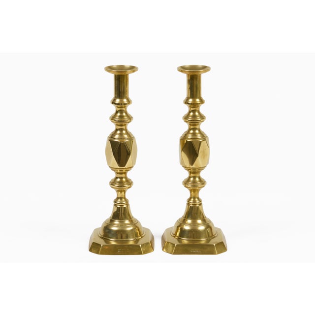 Antique pair of brass “Ace of Diamonds” candlesticks featuring a multi-faceted diamond-shaped knop or bulge in the center...