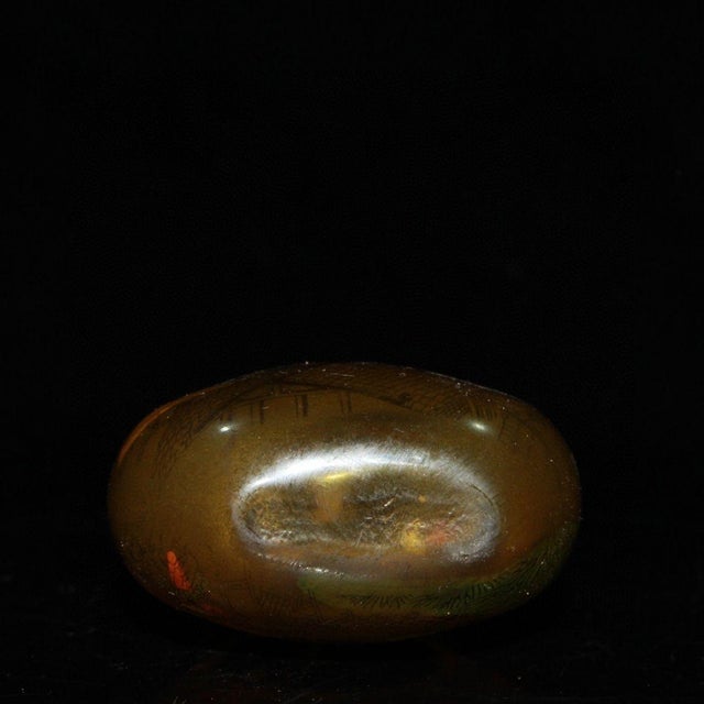 This gourd-shaped glass snuff bottle is a lovely piece of traditional Chinese decorative art. The interior of the bottle...