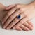 A vintage trilogy ring from circa 1990 in 18k gold, centered on a natural unheated Madagascar sapphire of 3.55 carats — a...