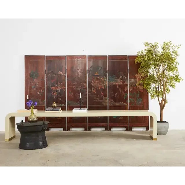 Beautifully weathered patina Chinese export lacquered coromandel screen with six double sided panels. The screen features...