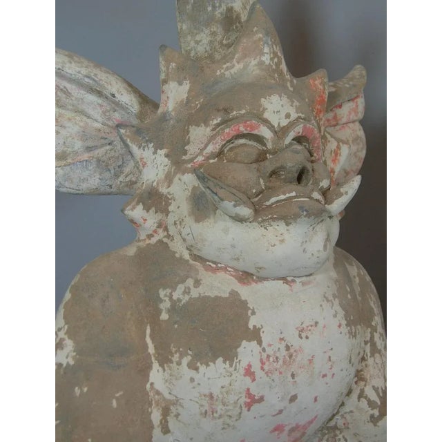 Two large early Chinese terra-cotta / earthenware (red and gray pottery) sculptures of ferocious creatures/earth spirits...