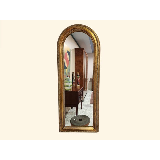 It is a baroque and neoclassical style mirror. It has an ornate frame with numerous details and its curvature gives it an...