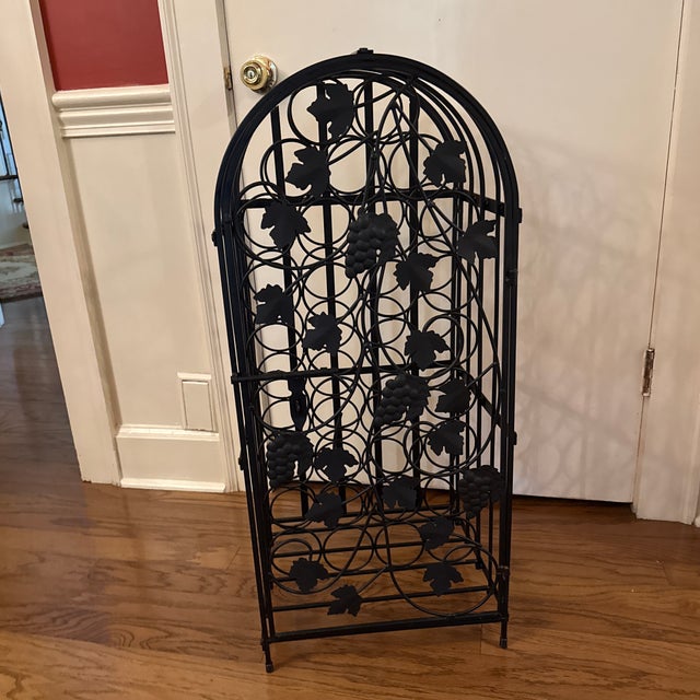 Italian iron wine cage of arched form with door featuring bunches of grapes and foliage, door with latch so it can be...