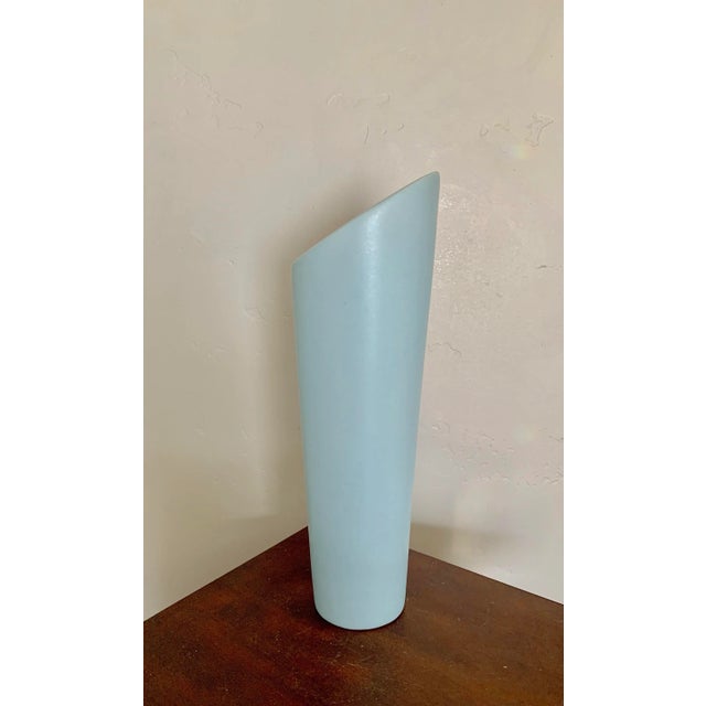 Modern asymmetric ceramic vase with light blue glaze. Tall and sleek, this vase makes a great addition to any modern or...