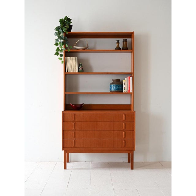 Teak bookcase with integrated chest of drawers, four large drawers and open shelves. Design by Bertil Fridhagen for...