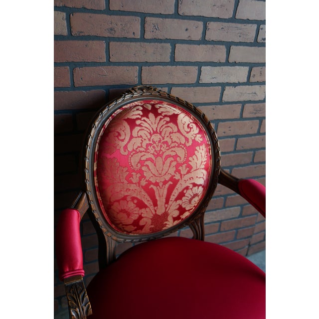 Quintessential French Style! This antique carved walnut frame arm chair showcases the fine carved craftsmanship of a...