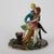 Meuguelman French Porcelain Figural Grouping Signed 20thC. Measures - 6.25" x6" x6". A French porcelain figural grouping...