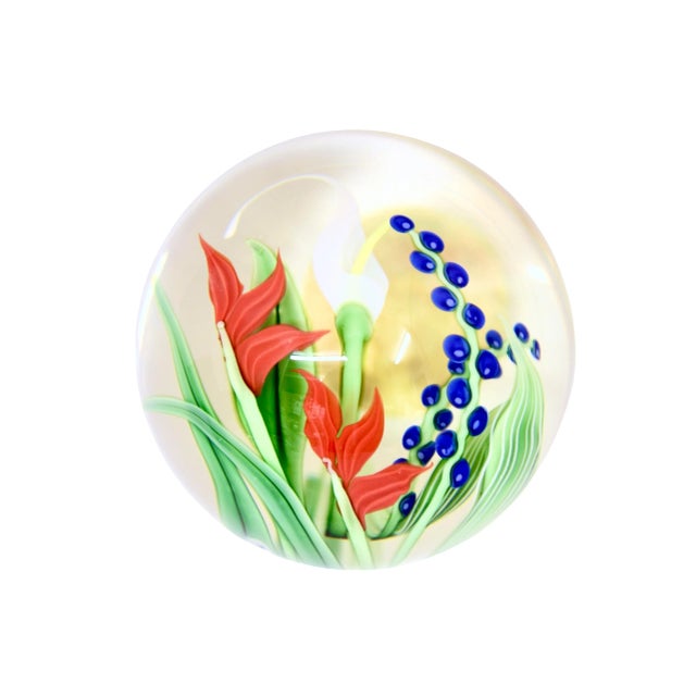 Vintage hand blown art glass sphere paperweight featuring intricate red, white and blue tulip style flowers. Flat cut...
