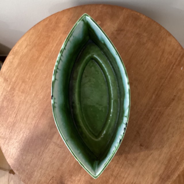 The product is a handmade Japanese ceramic vessel featuring a unique green glaze that gives a distinctive look. This piece...