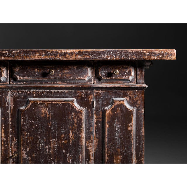 Handcrafted in Italy from solid wood, this rustic sideboard features a distressed burgundy finish with rubbed edges that...