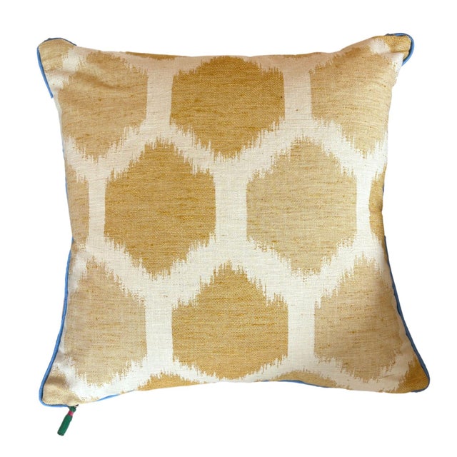 This front of this pillow has cheerful palette of alternating stripes of rose pink, lemon yellow, olive green, and...