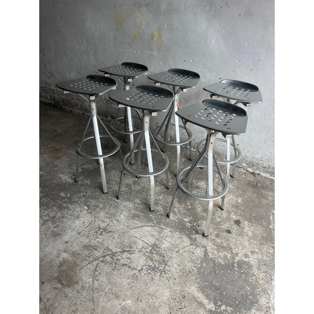A striking set of six industrial bar stools in aluminium, featuring a clean and functional design. These stools combine...