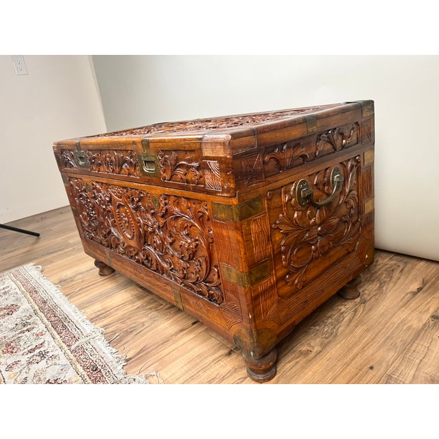 A beautifully hand-carved Chinese Export camphor wood dowry chest, richly decorated with traditional motifs and crafted as...