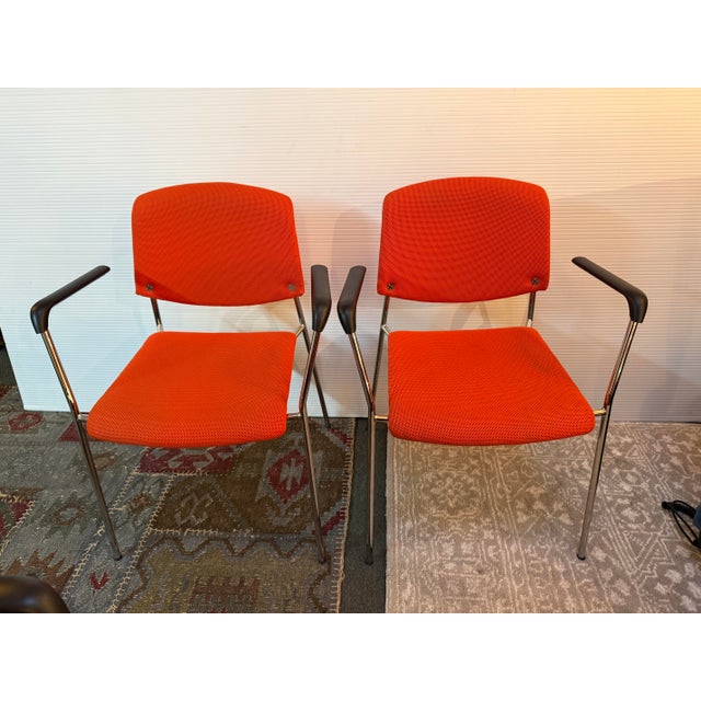 Design Plus Gallery presents a Pair of Orange Modernist Arm Chairs from HighTower. The chairs are cloth wrapped in a fire...