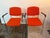 Design Plus Gallery presents a Pair of Orange Modernist Arm Chairs from HighTower. The chairs are cloth wrapped in a fire...