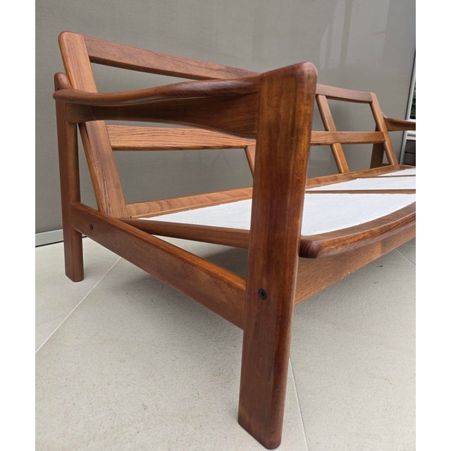 Elegant mid-century Scandinavian modern three-seat sofa frame crafted in solid teak or teak-stained hardwood, produced in...