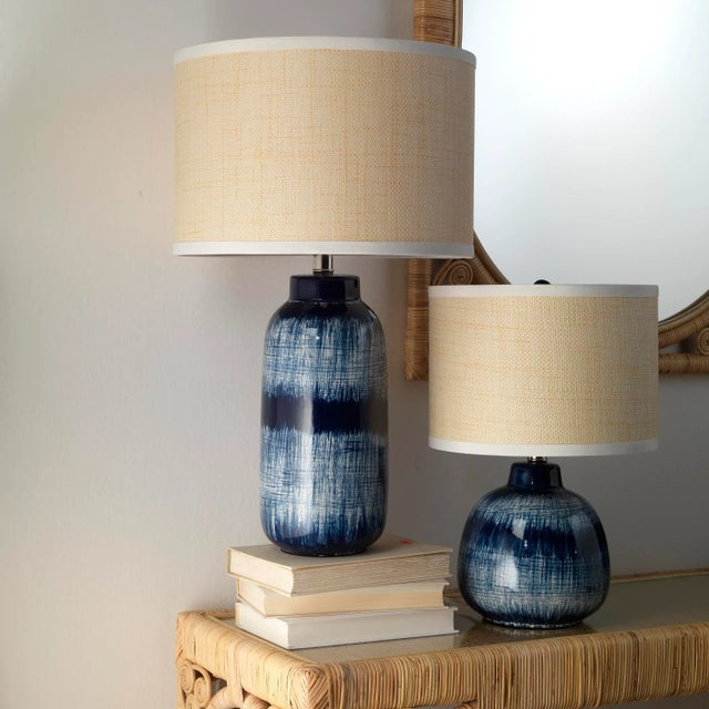 Inspired by Japanese ceramics, this lamp is a stunning ceramic accent that features a deep indigo reactive glaze that...