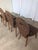 Vintage wooden dining chairs made in Yugoslavia, circa 1960s–1970s. The chairs feature a charming rustic folk design with...