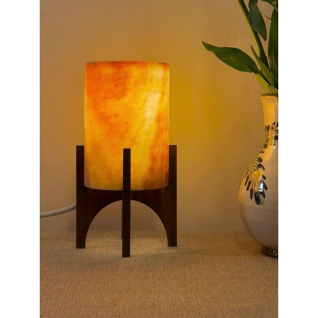 Comet pairs a hand-carved Egyptian alabaster shade with a geometric walnut base, combining contemporary form with...