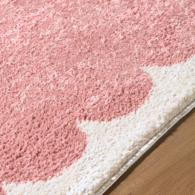Step into the realm of cozy minimalism with the Fossay Shag area rug, where modern design meets plush comfort. This...