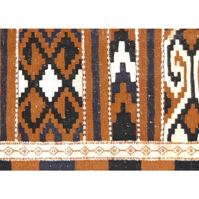 This vintage Turkish Kilim, measuring 3'2" x 6'1", is handwoven with wool on a wool foundation in Turkey's Oushak region....