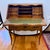 Charming antique French secretary desk with a warm, timeworn wood patina, graceful cabriole legs, scalloped details, and...