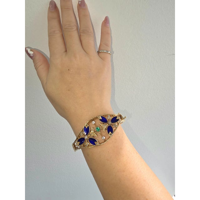 We offer free 2-day shipping! This is a vintage bangle featuring guilloche enamel, old cut diamonds and a single Colombian...