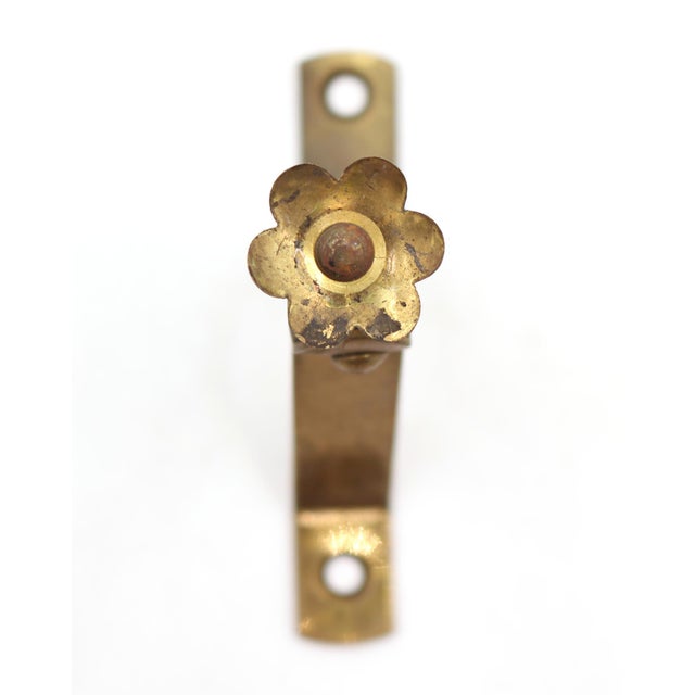 Vintage curtain rod brackets made of brass with a floral screw head. The original mounting screws are not available. Good...