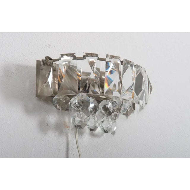 Brass frame, nickel-plated, fitted with three E14 sockets up to 60 watts. Covered with faceted crystal prisms....