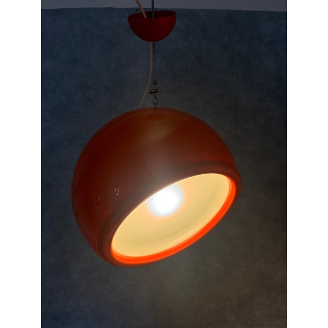A striking orange pallade pendant lamp designed by studio tetrarch for the italian lighting company artemide in the 1960s....
