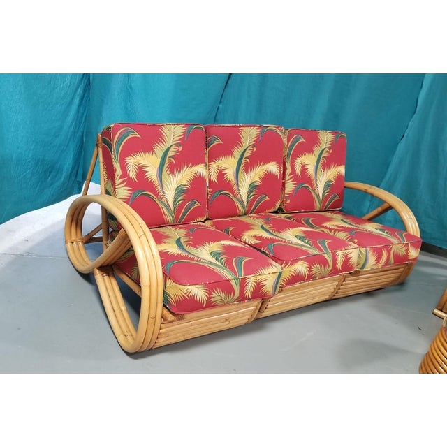 3 piece living room set of restored rattan furniture. A 3/4 pretzel arm sofa that is made up of 3 pieces and 3 seats and...