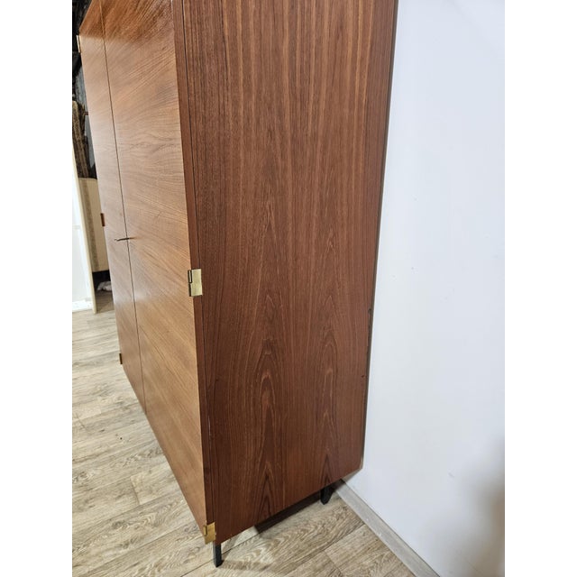Classic, two-door wardrobe in the Mid-Century Modern style from the 1960s. It is characterized by a simple, geometric form...