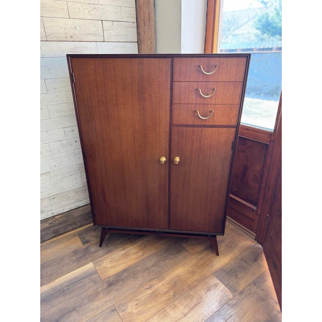 This stunning Mid-Century Armoire by Meredew is a true reflection of British craftsmanship from the 1960s, blending...
