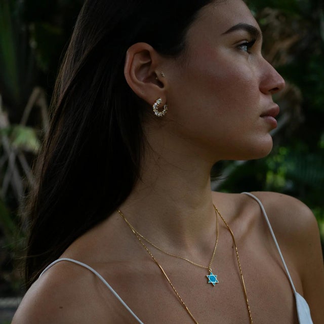 Shine with pure elegance in the Crystal Radiance Stud Hoop Earrings. Featuring clear, diamond-like stones, these earrings...