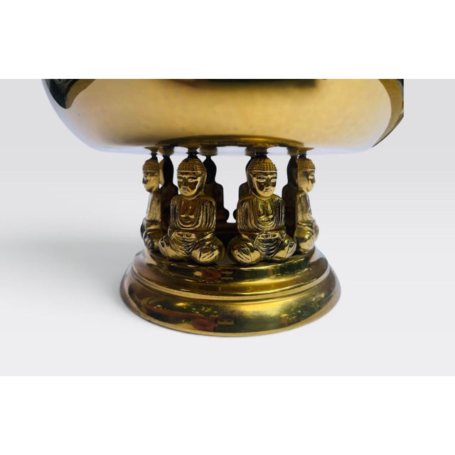 Vintage brass bowl/pot with seated Buddha figures holding the bowl. Can be used for a planter and bowl.
