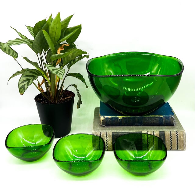 Beautiful set of four vintage emerald green glass bowls by French maker Vereco. These striking bowls feature a softly...