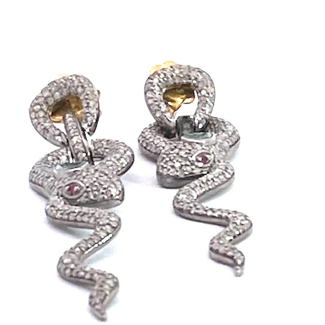 These earrings are done in Silver with green stones for the head and two red stones for eyes. These earrings are not fine...