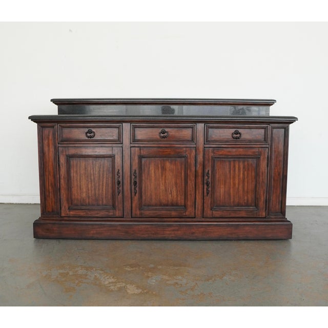 This traditional freestanding bar by Ambella Home Collection features a richly finished wood case accented with elegant...