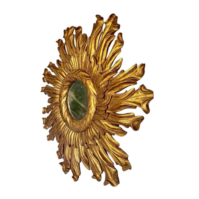 An exuberant Baroque style sunburst mirror; a classic on a grand scale! Frames are boldly hand-carved and finished in gilt...