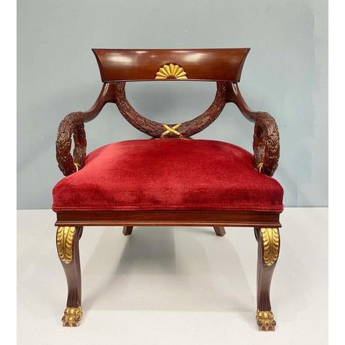 Pair Regency Revival armchairs with parcel gilt accents A scrolled crest rail with a central gilded fan motif, adding a...