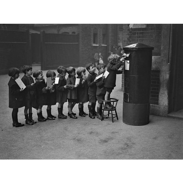 Post Queue December 1926: Schoolchildren posting letters in the playground of the Red Lion Street School. (Photo by Fox...