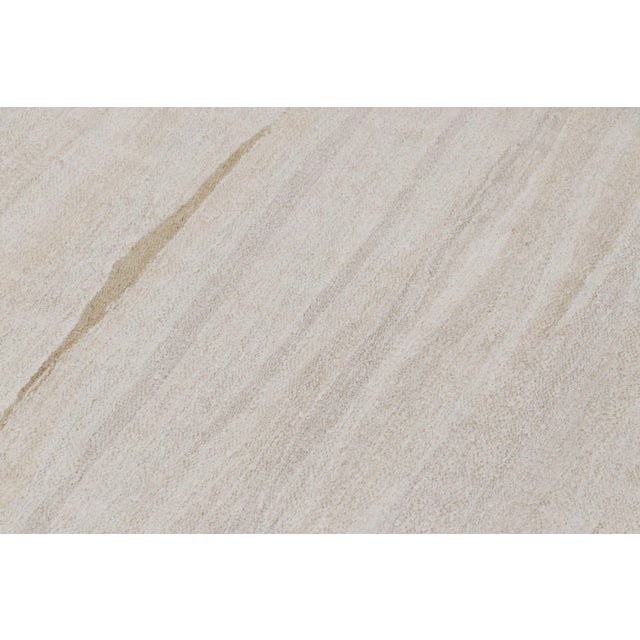 Handwoven in wool, circa 1950-1960, this 11x14 vintage kilim is among a special new curation of simple, near monochromatic...