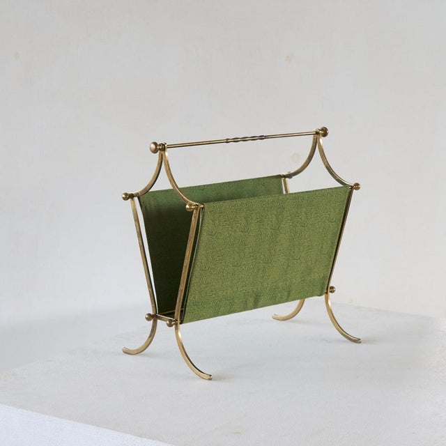 Elegant Mid Century Magazine Rack in Patinated Brass and Green Fabric. A very elegant mid century magazine rack / stand in...