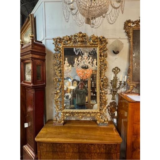This 19th Century Carved and Giltwood Mirror from Florence, Italy features a luxurious design that showcases intricate...