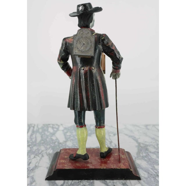 Metal Black Forest clock Staiger West Germany. Cast iron statuette of a cavalier with a walking stick in his hand and a...