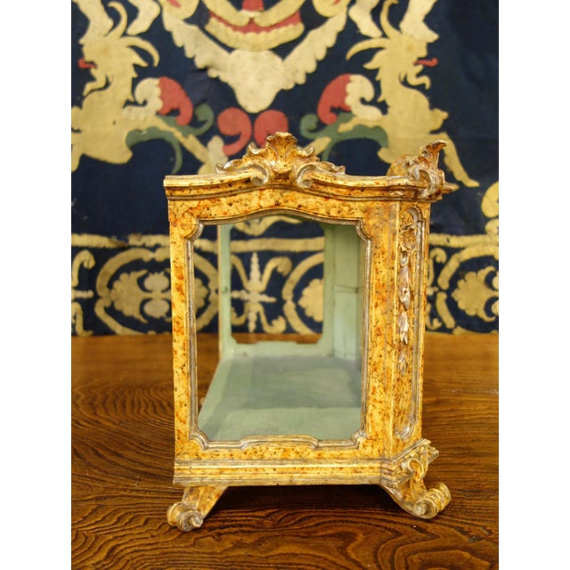An elegantly detailed, late 18th century Louis XV period wooden display case, golden yellow lacquer with silver leaf...